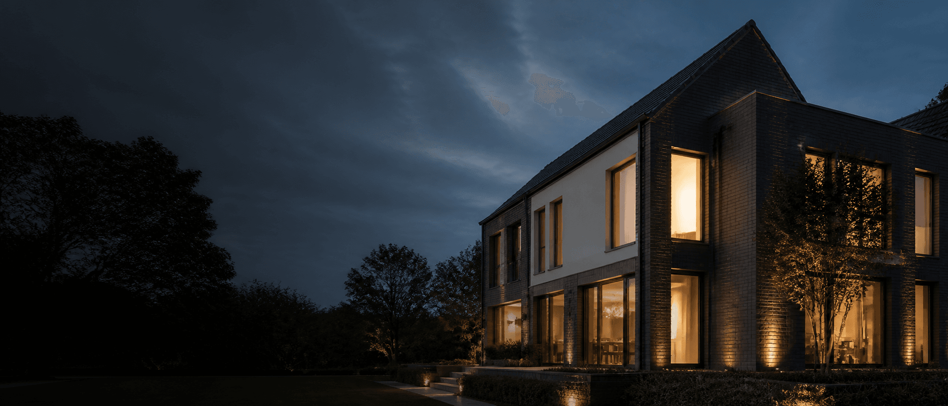 Modernisiertes deutsches Wohnhaus mit warm beleuchteten Innenräumen bei Dämmerung